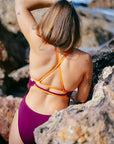 Close up of the JAYD Swimwear Airlie one full coverage piece, featuring a semi-adjustable cross-back design with triple base straps for optimal support.