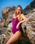JAYD model Cass wearing the limited edition sangria Airlie one piece with flare orange contrasting shoulder straps.