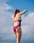 JAYD Swimwear model wearing the full coverage, Airlie one piece swimsuit in sangria.