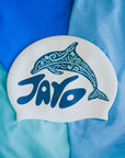 White swim cap with blue dolphin design and 'JAYD' text on a blue background