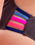 Close up of the Lennox one piece in cacao with contrasting multi-coloured straps.
