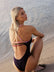 Paralympic swimmer Keira wears the contrasting Airlie one piece in the colour Acai with Fairy Floss straps and back detailing. This piece is designed for leisure and training.