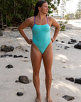 JAYD Swimwear fixed back athletic one piece called Zambia. This front on image showcases the body colour Seasmist with contrasting Murasaki cut outs and straps.
