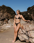 Athlete Emily wears the fixed back top by JAYD swimwear in the colour Cacao. Swim top is the Kiama top and is built to help you dive in with confidence.