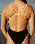 JAYD Swimwear athlete Jenaya wears the fixed back Finley one piece in the colour black with contrasting sunshine straps. this piece is ideal for teams or clubs.