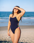 JAYD Swimwear athlete and Cure Cancer collection Designer Madi Armstrong wears the Ibiza one piece with the body colour Acai and contrasting Kiwi straps and hip cut outs.