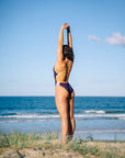 JAYD Swiwmwear design active swimwear one piece, Ibiza style in Acai with Kiwi and Tart contrasting straps. Worn by the ocean