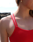 Up close image of the front detailing of JAYD Swimwear's athletic Finley one piece in the Ruby colour.