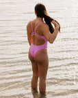Athlete Jenaya wears the fixed back one piece by JAYD swimwear called Zimmy. She is wearing the colour fairy floss.