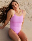 Athlete Jenaya wears the Zimmy one piece by JAYD Swimwear in the colour Fairy Floss. This one piece offers a cheeky coverage and is built for performance.