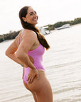 Surf Ironwoman Jenaya wears the fixed back Zimmy one piece by JAYD Swiwmear in the colour Fairy Floss, she wears it for surf ironwoman training and loves the cheeky coverage.