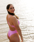Athlete Jenaya wears the Zimmy one piece by JAYD Swimwear in the coluor Fairy Floss, this piece offers a cheeky coverage and is built for performance.