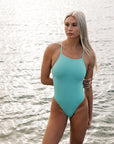 Swimmer Keria wears the Tallow fixed back one piece by JAYD Swimwear in the colour seamist. The Tallow offers full coverage and is made from chorine resistant material
