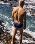 Tanner wears the Navy Ramshark men’s swim bottom by JAYD Swimwear while ocean training. Chlorine-resistant, performance-driven swimwear built for active water athletes.