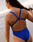 Ski Paddling athlete Jenaya wears the wider strapped fixed back one piece by JAYD Swimwear, in the colour Cobalt. This mid coverage one piece is called the Soraya.