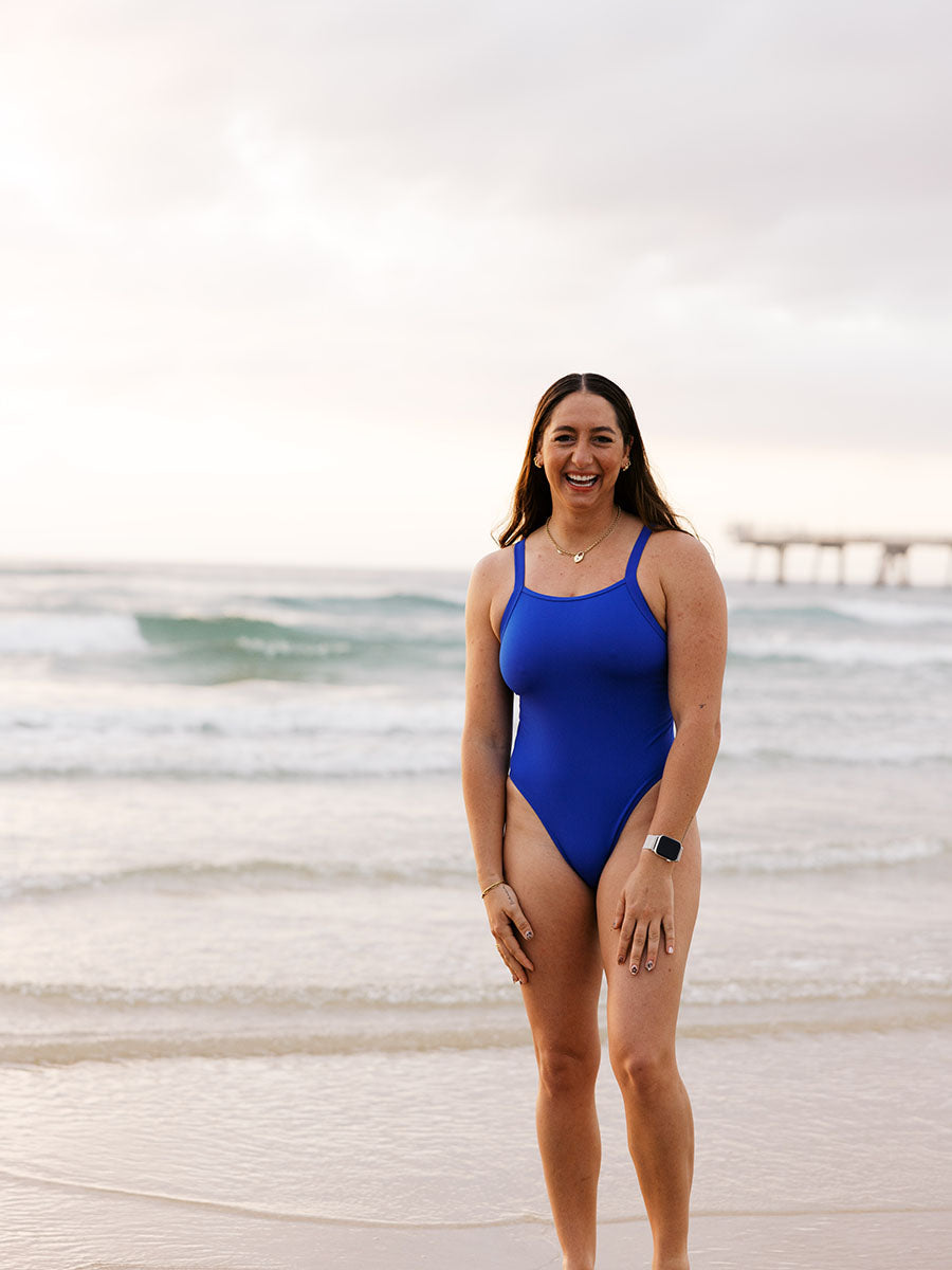 Athlete Jenaya wears a cobalt blue one piece designed by JAYD Swimwear. This one piece offers mid bum coverage and is perfect for both the beach and the pool.