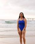 Athlete Jenaya wears a cobalt blue one piece designed by JAYD Swimwear. This one piece offers mid bum coverage and is perfect for both the beach and the pool.