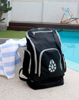 JAYD Swimwear black backpack sitting poolside.
