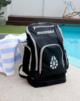 Black backpack with 'MOONERS' branding by a poolside