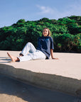 Navy oversized JAYD Swimwear t-shirt with a light blue coastal graphic on the back, an everyday boxy fit tee for lounging, beach days, or after a swim.