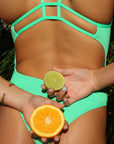 Close back view of JAYD Swimwear athletic one piece Zimmy in Meadow Green.