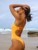 Side view of model on the beach wearing JAYD Swimwear athletic Zimmy one piece in colour shade Sunshine.