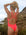 Back view of model on the beach wearing JAYD Swimwear athletic Finley one piece in colour shade Fiesta.