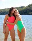 Group image of two girls wearing JAYD Swimwear tallow one pieces. One is wearing the Fiesta shade and the other is in our Meadow shade