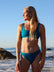 Front view of model on beach wearing JAYD Swimwear cheeky bikini bottom Demi in Nordic Blue.