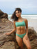 Front view of model wearing JAYD Swimwear athletic Torquay training bikini top in Matcha green.