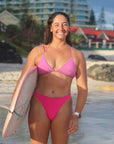 Front view of seamless, athletic, full coverage JAYD Swimwear Cali bikini bottoms in Pink Sorbet.
