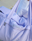 Close view of silver JAYD Logo on JAYD Swimwear Duffel Bag in Purple.