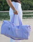 Model holding JAYD Swimwear Duffel Bag in Purple.