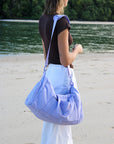 Model wearing shoulder strap JAYD Swimwear Duffel Bag in Purple.