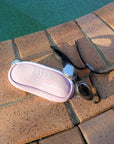 JAYD Swimwear Pink Goggle Bag with goggles on pool deck.