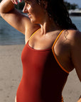 JAYD Swimwear athletic fixed back one piece, Lennox worn by open water swimmer Madi. She wears the cinnamon colour with contrasting sunshine straps and hip cut-outs. This piece is designed in Australia and is made from chlorine resistant material