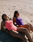 Female athlete in JAYD Swimwear Albi One Piece Vibe and Murasaki, designed for ocean swims, pool training, and surf life saving