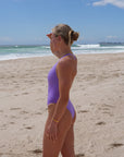 The Levanto One Piece swimsuit by JAYD Swimwear, in Lilac Haze. Side view with mid coverage.