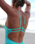 JAYD Swimwear Zimmy one piece athletic swimsuit in sea mist, close up of the detailing on the back of the suit