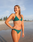 Front view of athletic cross-back JAYD Swimwear Kiama bikini top in Cove green.