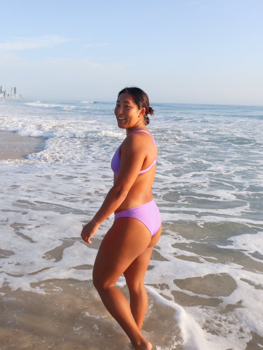 Side view of seamless JAYD Swimwear Cali athletic bikini bottoms in Lilac Haze