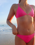 Front view of cross-back, athletic JAYD Swimwear Kiama bikini top in Pink Sorbet.