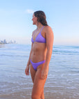 Side view of athletic cross-back JAYD Swimwear Kiama bikini top in Lilac Haze.