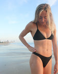 Close view of athletic cross-back JAYD Swimwear Kiama bikini top in Black.