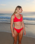 Front view of JAYD Swimwear Tazzie athletic bikini top in Ruby Red