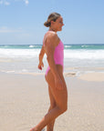 Side view of Apsley One Piece Athletic Swimsuit in Fairy Floss Pink by JAYD Swimwear