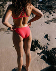 Madi wears the Connie bottom, our fullest coverage bikini swim bottom in Fiesta, paired with the Tazzie top.