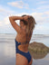 JAYD Swimwear Zimmy one piece athletic swimsuit in navy, view of the back of the suit on the beach