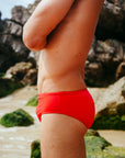 Bold, secure, comfortable. Close up view of the red JAYD Swimwear Ramshark bottoms.