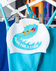 White Swimcap with 3 people body surfing and 'Swim for a cure' text.